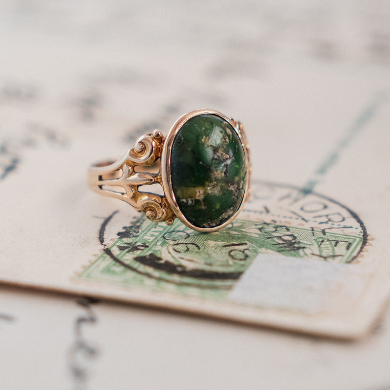Oval Turquoise Cabochon (10kt) Ring with fleur-de-lis shoulders